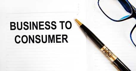 Business concept. On the table is a calculator, diary, markers, pencils and a notebook with the inscription - Business to Consumer