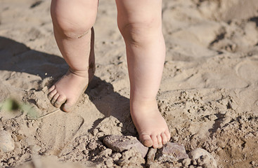 Little kids leds in sand on the beach