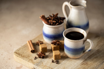 Cafe de olla, traditional Mexican coffee beverage with panela and spice and prepared in clay pot.