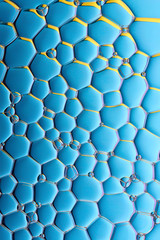 Current collection of brilliant backgrounds for your design. Close-up shot of flattened oil drops on water surface in blue, yellow and violet colors.