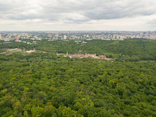 Fototapeta na wymiar Aerial drone view. Buildings in the forest in Kiev.