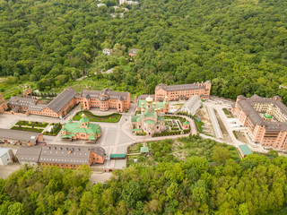 Aerial drone view. Holy Intercession Holosiivsky Monastery. Monastery among the woods in Kiev.