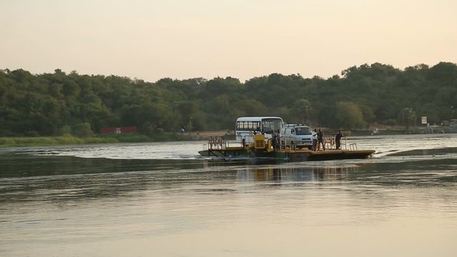 ars and children going down from a ferry on the Nile, Uganda