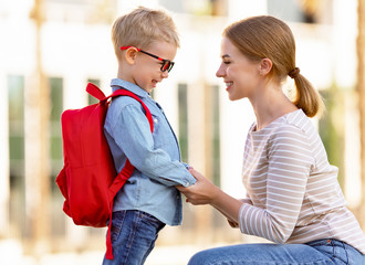 Mother speaking with son before school.