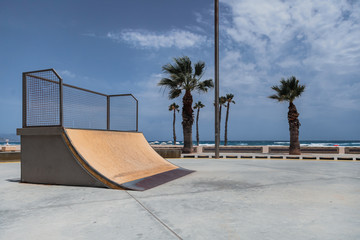 Empty skate park ramp outdoor in seaside beach - obrazy, fototapety, plakaty