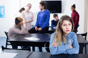 New girl student feeling shy at recess during school day