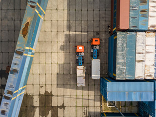 Multicolored freight containers on the railroad. Aerial drone view.