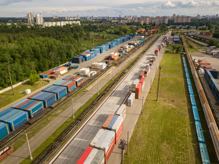 Multicolored freight containers on the railroad. Aerial drone view.