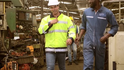 Engineers and workers, machine repair factories Walk out of the factory after the work time expires