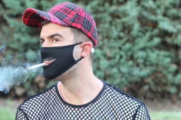 Smoker wearing protective mask with a zipper 