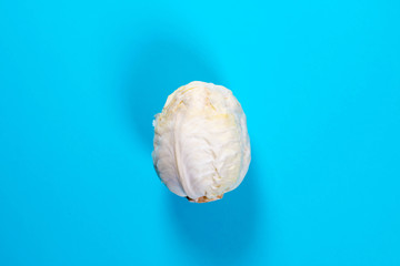 Fresh organic cabbage on blue background. Top view.