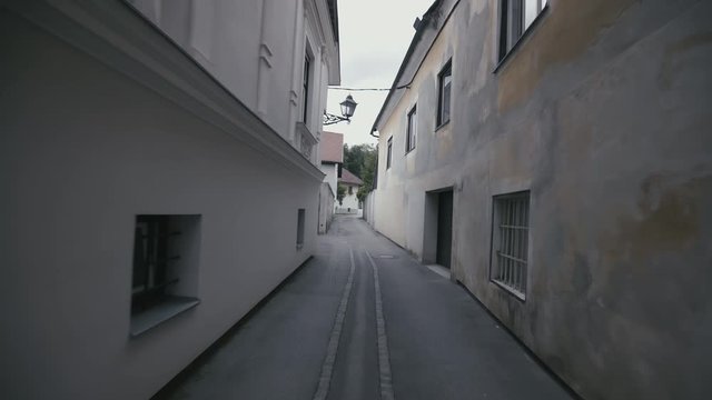 Walking through narrow alley on gimbal stabilizer 4K