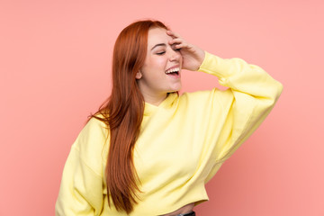 Redhead teenager girl over isolated pink background has realized something and intending the solution
