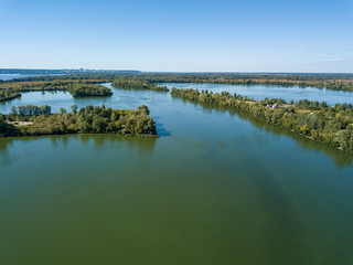 Panoramic view of the Dnieper river in Kiev. Sunny clear day. Aerial drone view.