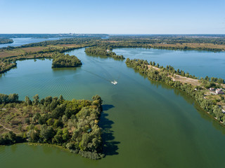 Panoramic view of the Dnieper river in Kiev. Sunny clear day. Aerial drone view.
