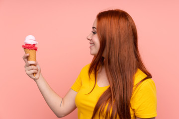 Young girl with a cornet ice cream over isolated background with happy expression