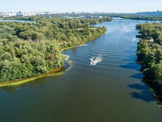 Motor boat in the Dnipro river. Sunny clear summer day. Aerial drone view.