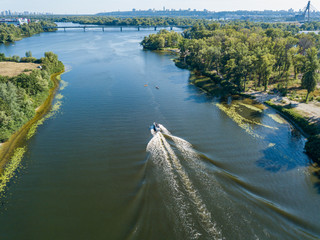 Obraz premium Motor boat in the Dnipro river. Sunny clear summer day. Aerial drone view.