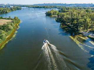 Naklejka premium Motor boat in the Dnipro river. Sunny clear summer day. Aerial drone view.