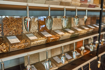 .Shelves with glass cells filled with nuts and cereals..Zero waste shopping concept