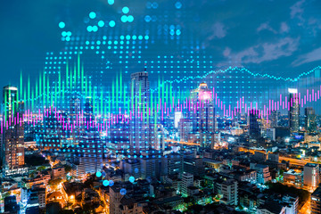 Fototapeta na wymiar Stock market graph hologram, night panorama city view of Bangkok, popular location to gain financial education in Asia. The concept of international research. Double exposure.