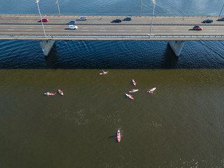 Aerial drone view. Kayak boats under the bridge.