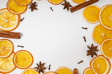 Dry oranges, anise, cloves and cinnamon on the white background