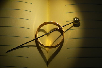 Wedding ring, creating shape of a heart.