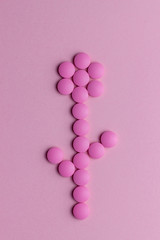 Flower made from pills on a pink background. Health. Medicine. Pharmacy.