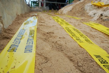 Underground warning tape placed on the sand to alert the underground power lines in the chemical...