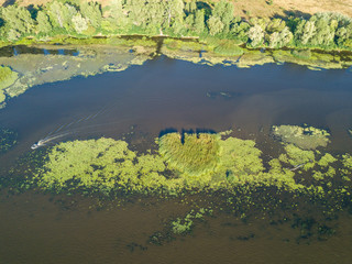 Green bank of the Dnieper river on a summer sunny day. Aerial drone view.
