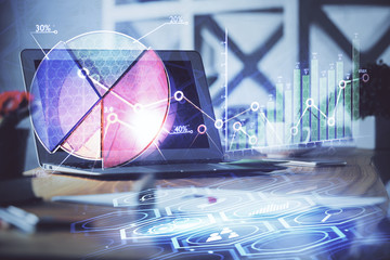 Financial graph colorful drawing and table with computer on background. Double exposure. Concept of international markets.