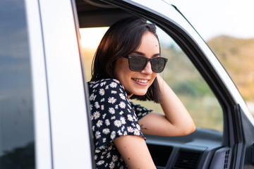 Fototapeta na wymiar Young caucasian woman in a van at outdoors