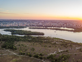 Obraz premium Aerial drone view. Sunset over the Dnieper River and the city of Kiev.