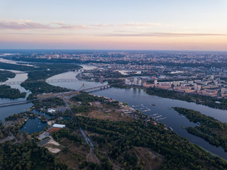 Fototapeta premium Aerial view. Dnieper river and Kiev city at dusk.