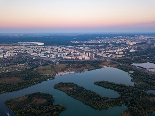 Fototapeta premium Aerial view. Dnieper river and Kiev city at dusk.