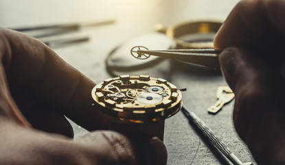 Watchmaker is repearing mechanical wrist watch