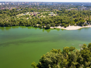 Aerial view. Bank of the Dnieper River. Algae bloom in the green water of the river.