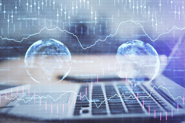Financial chart drawing and table with computer on background. Multi exposure. Concept of...