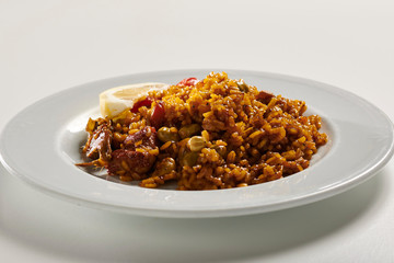 Traditional paella typical of Spain on white background