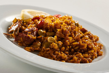 Traditional paella typical of Spain on white background