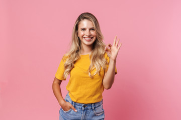 Happy young woman showing okay gesture.