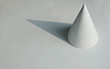 the geometric shape of the cone on white background, copy space