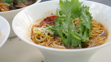 Healthy organic street food vegan options for a dinner or lunch.Vegan ramen soup served with tofu, soya meat, greens, mushrooms and seeweed