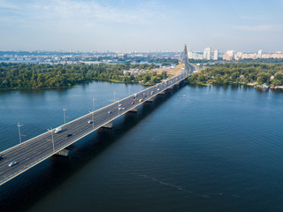 Fototapeta premium Dnieper River and North Bridge in Kiev. Sunny summer day, aerial drone view.
