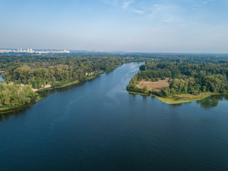 Fototapeta na wymiar Aerial drone view. Green bank of the Dnieper river on a summer sunny day.