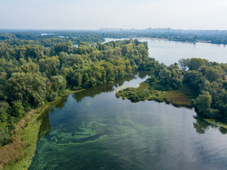 Aerial drone view. Green bank of the Dnieper river on a summer sunny day.