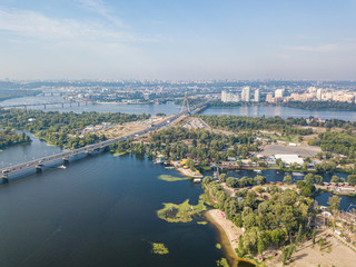 Dnieper River and North Bridge in Kiev. Sunny summer day, aerial drone view.
