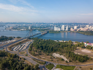 Obraz premium Dnieper River and North Bridge in Kiev. Sunny summer day, aerial drone view.