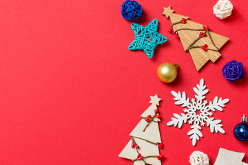 Top view of holiday decorations and toys on red background. Christmas ornament concept with empty space for your design